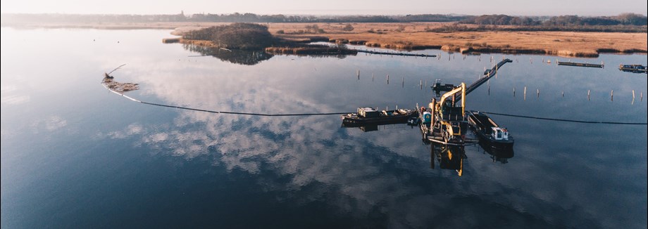 Construction equipment on a lake.